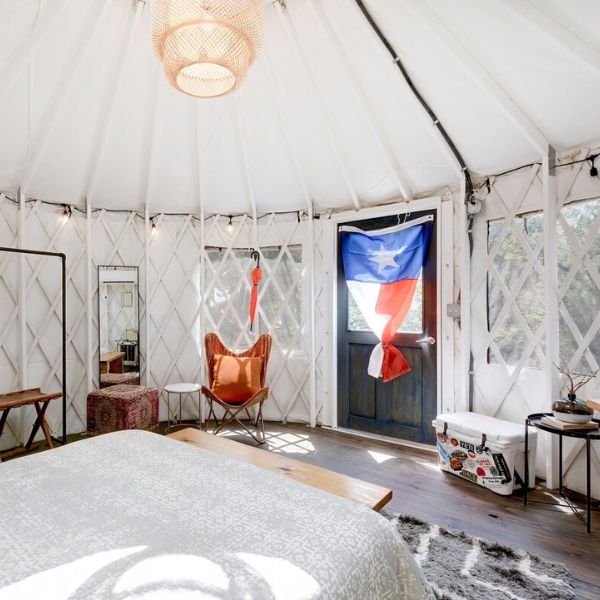 texas flag hanging from door in white yurt