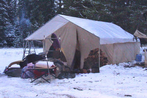 wall tent in winter with hunting gear