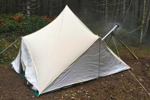 beckel tent in forest with stove pipe