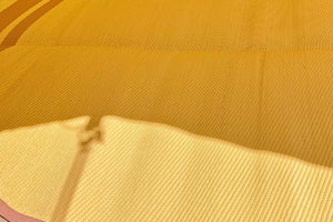 close up of yellow outdoor rug for tent