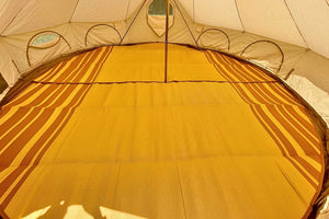 inside of life intents bell tent with a rug
