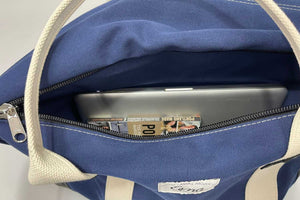 inside of blue canvas duffel bag with laptop