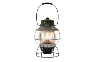 olive drab camping lantern with light on