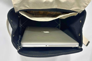 inside of blue canvas backpack with laptop