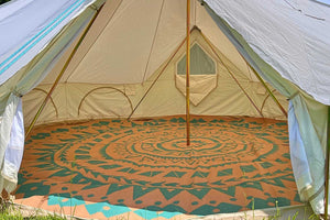 inside of a canvas bell tent with large window and rug cover