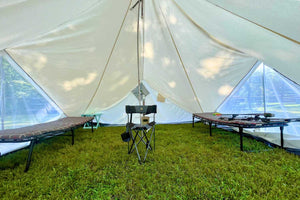 inside of canvas tent with cots