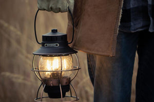 bronze barebones lantern in mans hand