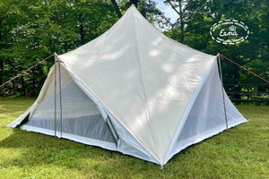 side of triangle tent near trees