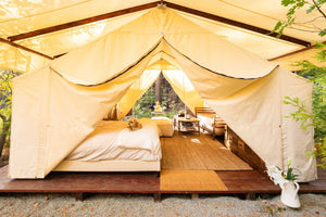 fancy glamping tent with nice bed