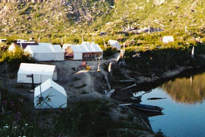 wall tent village on a river