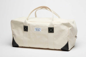 white and black canvas duffel bag